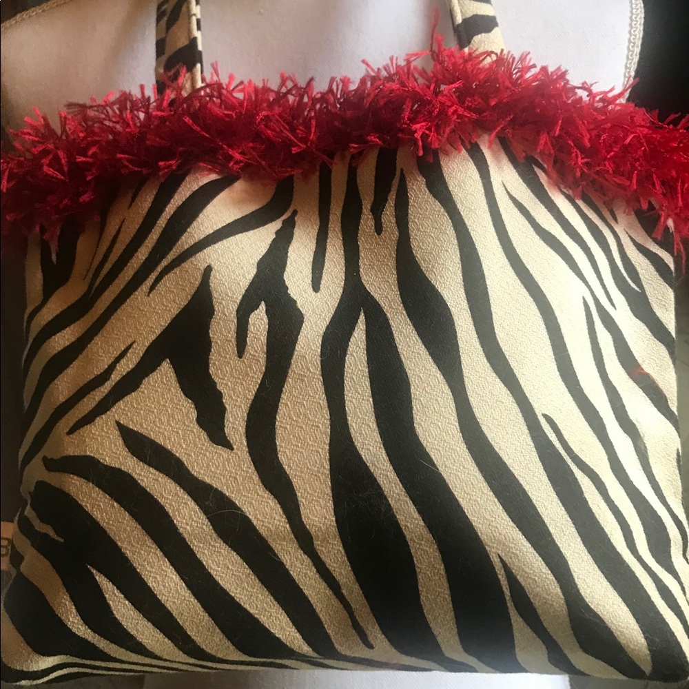 ZEBRA PRINT FABRIC PURSE WITH RED FRINGE